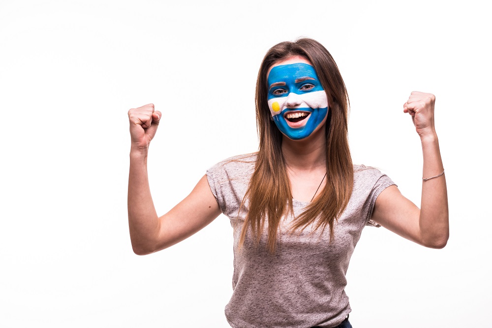 Mujer con la cara pintada de la bandera de Argentina